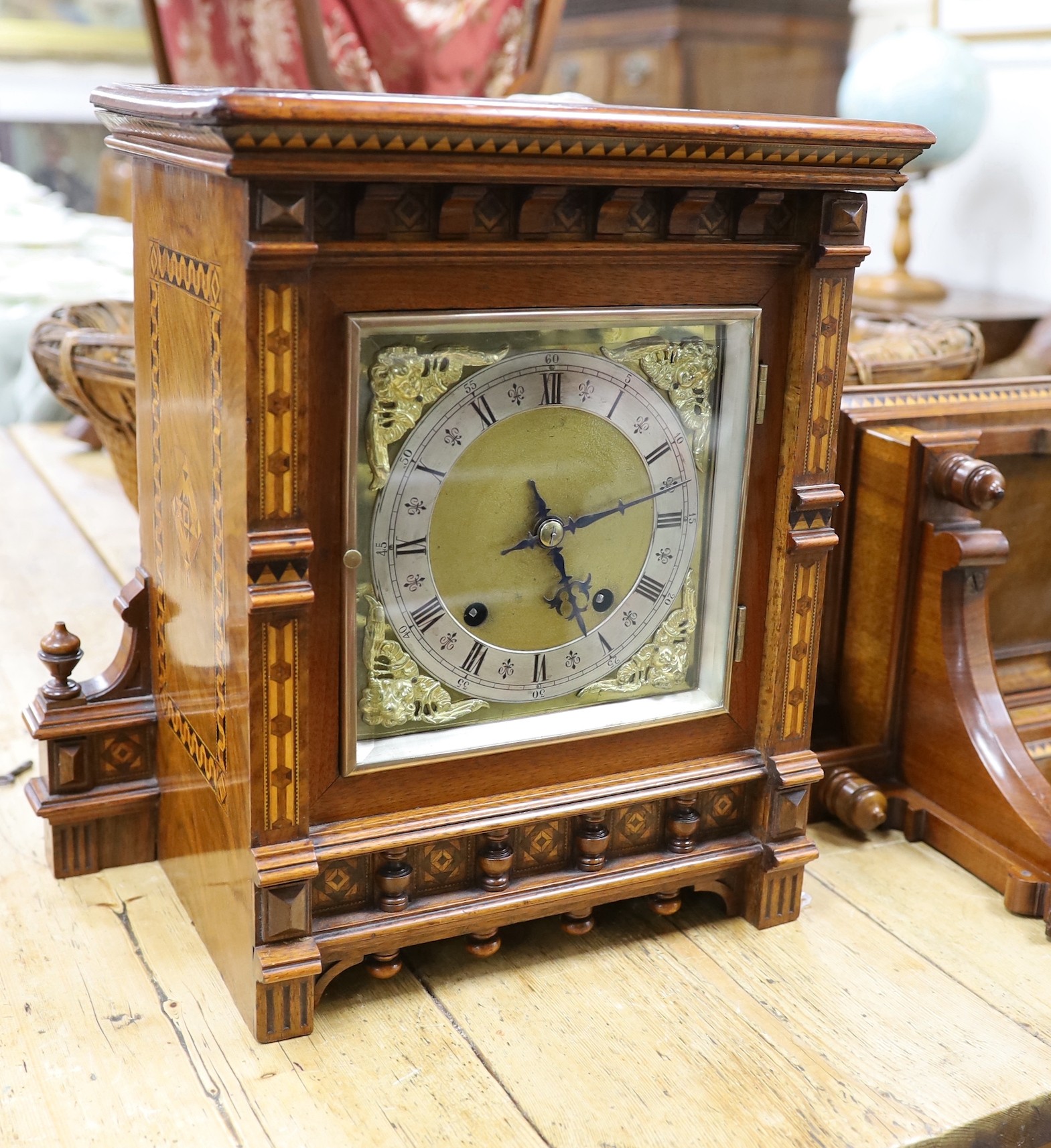 A late 19th century Arts and Crafts walnut and marquetry banded Tunbridgeware bracket clock with a German eight day quarter striking movement and bracket, clock 25cms wide x 35cms high, bracket 39cms wide x 26cms high